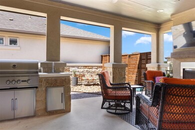 View of patio with area for grilling and fence