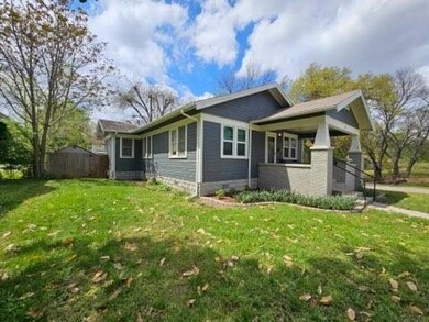 View of side of home with a lawn