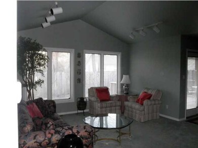 Living room has vaulted ceiling.