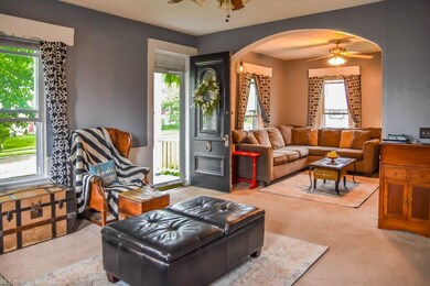 Spacious living room with an archway to a family r