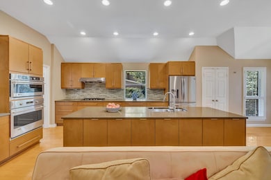 Kitchen featuring lofted ceiling, tasteful backsp