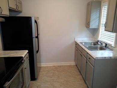 Kitchen featuring sink, light tile patterned floor