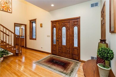 The beautiful front door that leads to a covered f