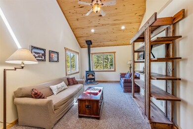 Living area with ceiling fan, wood ceiling, a wood