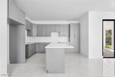 Kitchen featuring gray cabinets and a kitchen isla