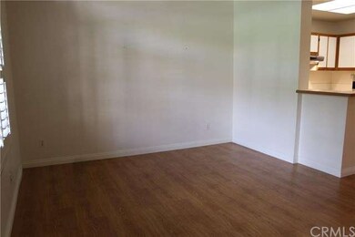 Large family room with hardwood flooring and plant