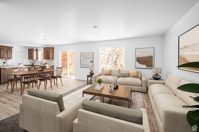 Living room featuring light wood-style floors and healthy amount of natural light