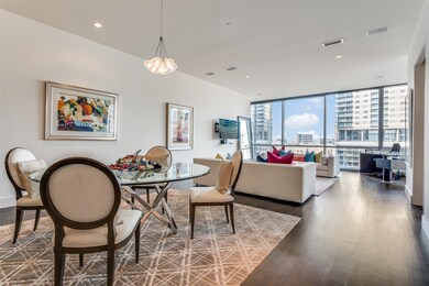 Dining room with a wall of windows, wood finished floors, recessed lighting, and a chandelier