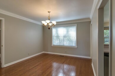 Bright and happy formal dining with gleaming woods