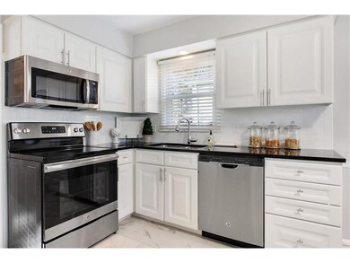 GE Stainless Steel appliances, black quartz tops, 