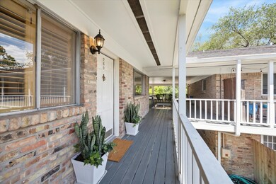 Welcome Home! The freshly painted front door and Entry, flanked by dual planters overlook a gorgeous courtyard with large fountains! Note the sprawling covered porch with numerous sitting areas, handsome brick, classic porch light and convenient front and back staircases! NICE!