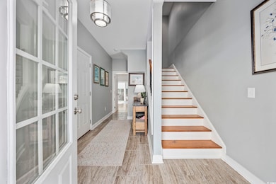 Foyer with stairs and baseboards