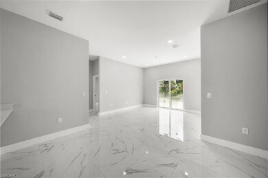 Spare room with light marble finish flooring and recessed lighting