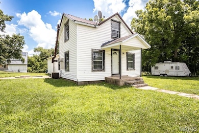 View of front of house featuring a front yard and a metal roof