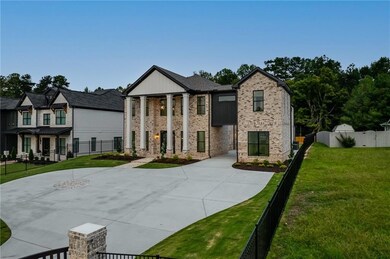 Neoclassical / greek revival house with driveway and brick siding