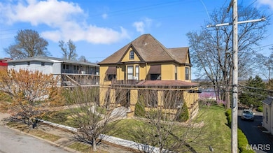 Victorian house with roof with shingles and stucco siding