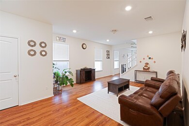 Living area with stairs, light wood finished floo