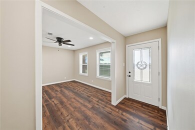 Foyer with dark wood-type flooring, a ceiling fan, and recessed lighting