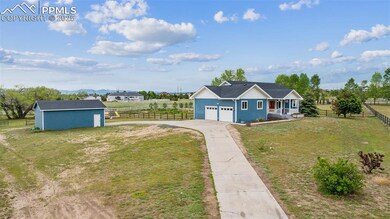 View of yard featuring driveway and an outbuilding
