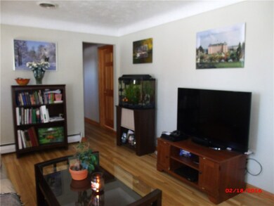 Spacious livingroom with gleaming hardwood floors.