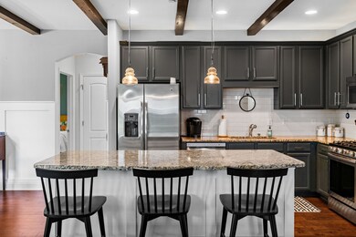 The kitchen is loaded with upgrades including a wide island and gorgeous granite counters.