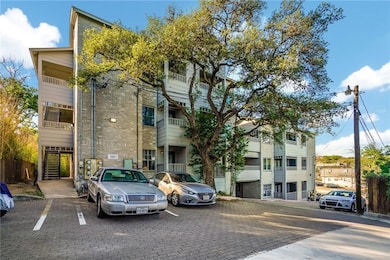 View of building exterior with uncovered parking