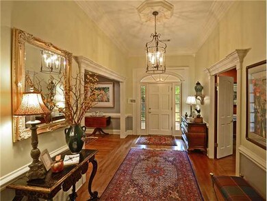 The entry's custom millwork, gleaming hardwood, 12