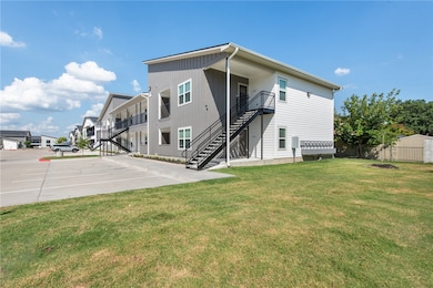 Rear view of house featuring stairway