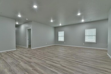 View of front of house with a garage, concrete driveway, and brick siding