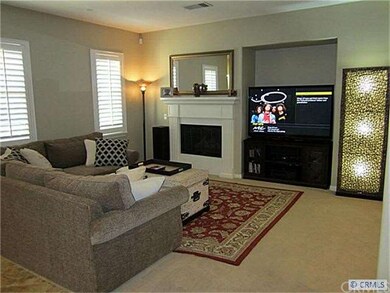 Living room with media niche and fireplace