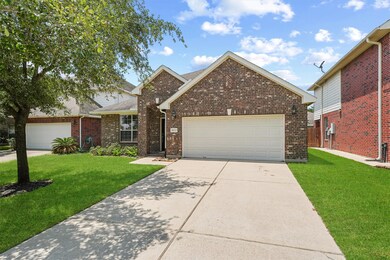 The spacious driveway leads to a two-car garage, providing ample parking and storage. The home's exterior is accented by thoughtful landscaping, adding to its curb appeal and inviting ambiance.
