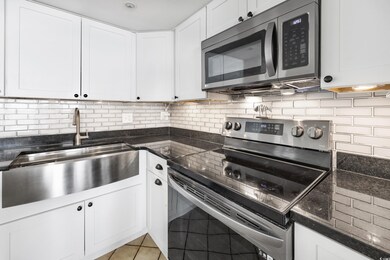 Kitchen with white cabinetry, stainless steel appl