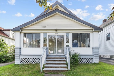 View of front of home featuring a sunroom and a front yard