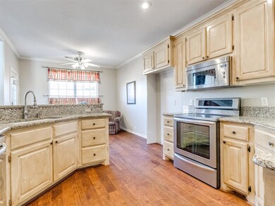 Kitchen featuring light brown cabinets, ornamental