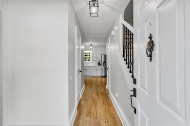 Hall featuring light flooring and stairway