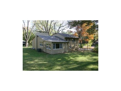 Rear view of house and sunroom.