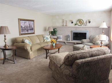 Living room with a textured ceiling, a fireplace, 