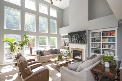 The expansive great room has a vented gas fireplace flanked by built in bookcases.  The 75