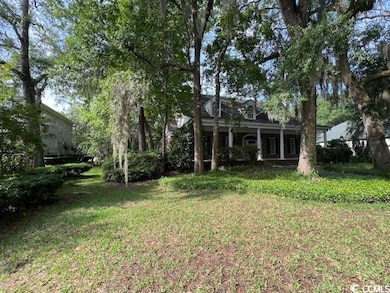 View of grassy yard with a porch