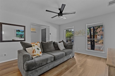 Living room with light wood-type flooring, ceilin