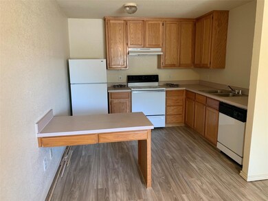 Kitchen featuring white appliances, sink, and ligh