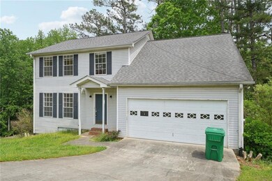 Colonial house featuring concrete driveway, a shin