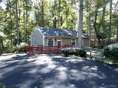 Front view of home with double wide paved driveway
