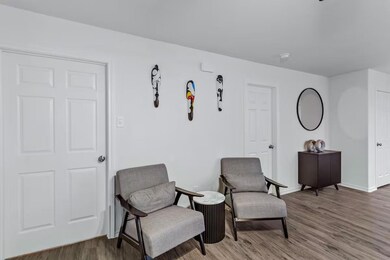 Sitting room with hardwood / wood-style floors