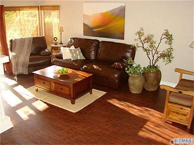 Living room with new wood floors and french doors.