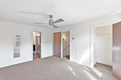 Unfurnished bedroom featuring carpet flooring, a closet, a ceiling fan, and connected bathroom