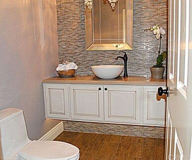 Designer powder room with glass chandelier, floati