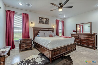 Spacious primary bedroom room with ceiling fan