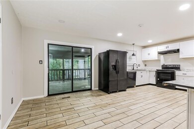 Kitchen featuring black appliances, under cabinet 