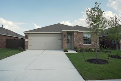 Single story home with brick siding, an attached 